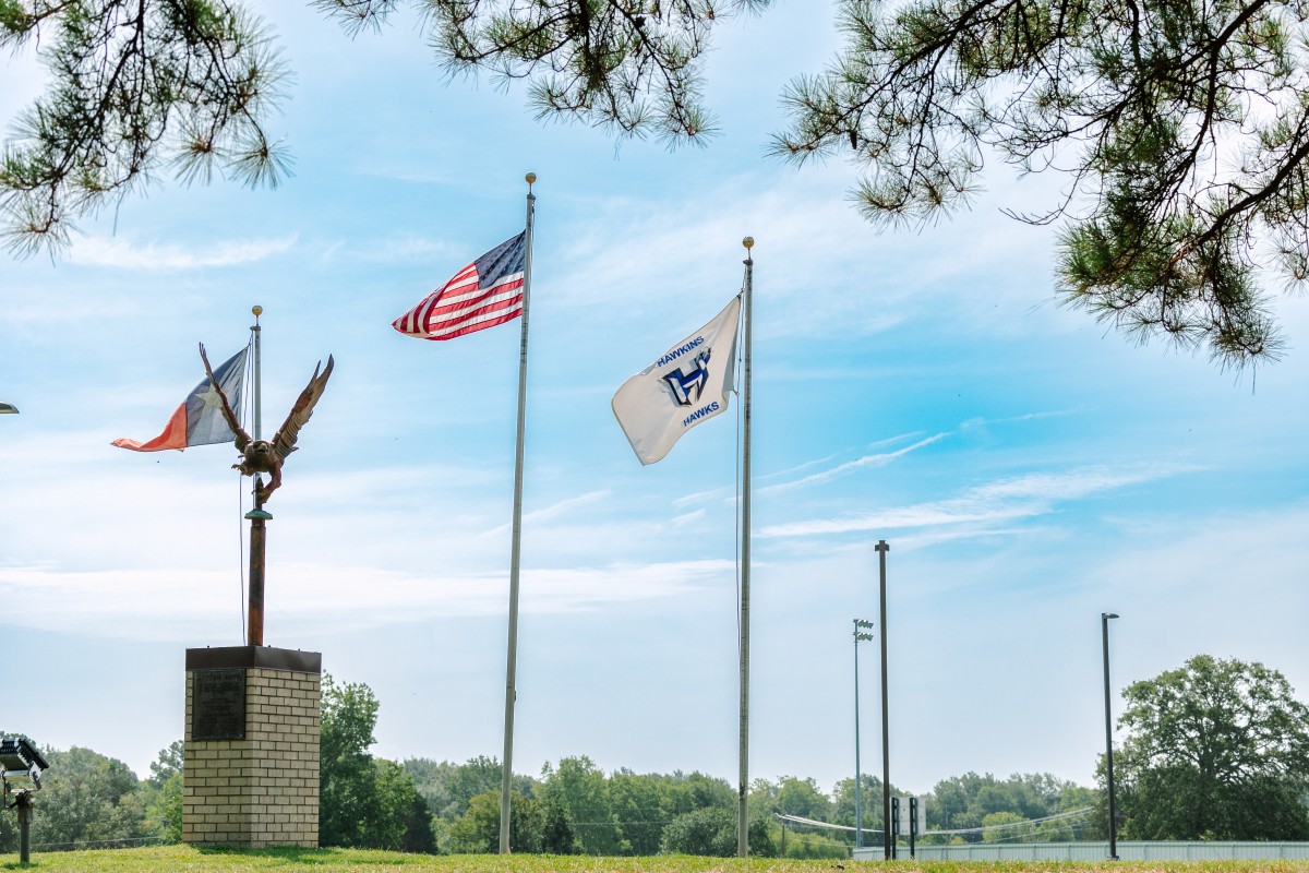 Pictures depicts 3 flag poles in Hawkins, TX